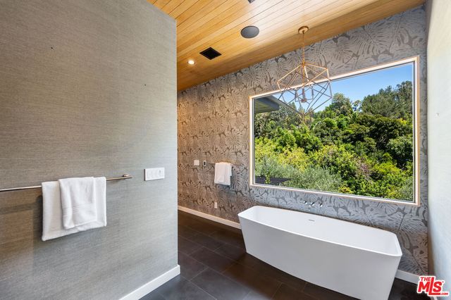 a bathroom with a bathtub and window