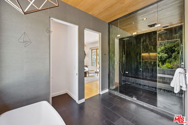 a bathroom with a toilet mirror and shower