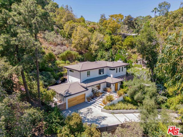 an aerial view of a house with a yard basket ball court and outdoor seating