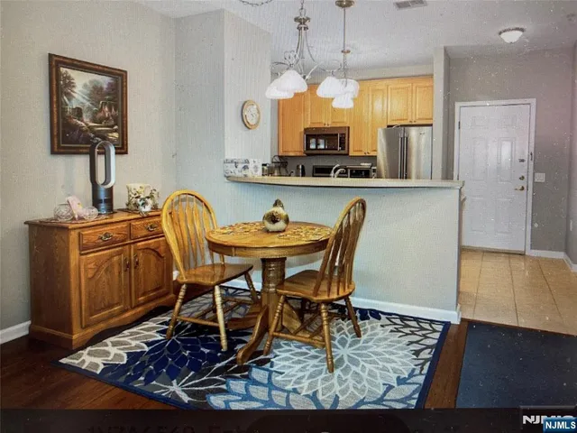 a view of a dining room with furniture and a chandelier