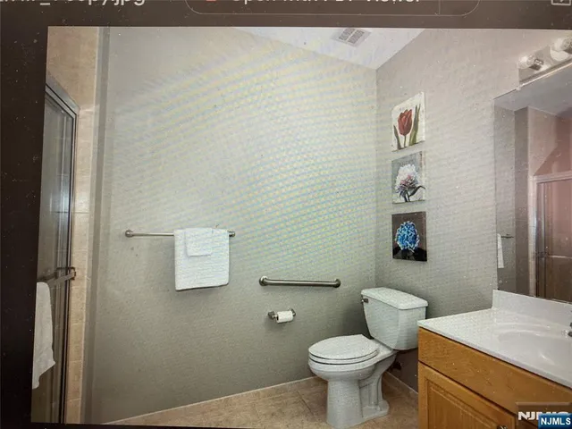 a white toilet sitting next to a bathroom sink