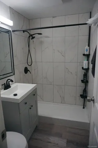 a bathroom with a sink toilet and shower