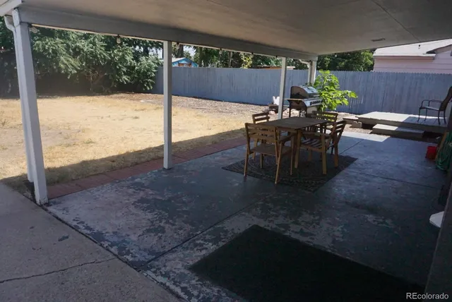 a view of a porch with furniture and yard