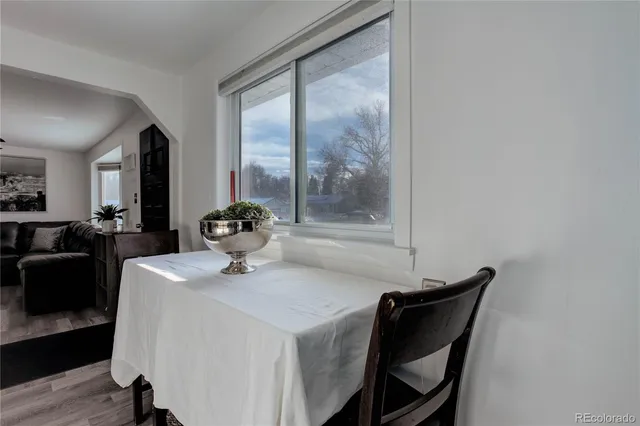 a dining room with furniture and wooden floor