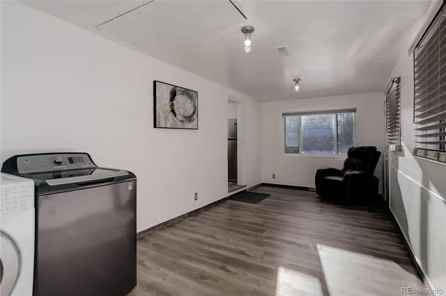 a living room with hard wood flooring and furniture