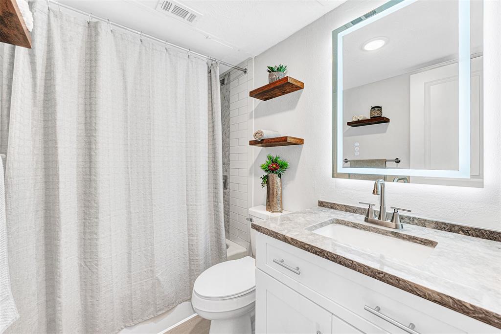 2809 Rio Branco Street, Unit 102 Farmers Branch, TX 75234 - Photo 12 of 21 a bathroom with a granite countertop sink and a mirror
