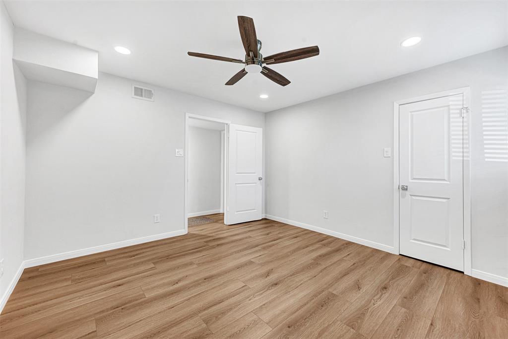 2809 Rio Branco Street, Unit 102 Farmers Branch, TX 75234 - Photo 14 of 21 wooden floor in an empty room with a window