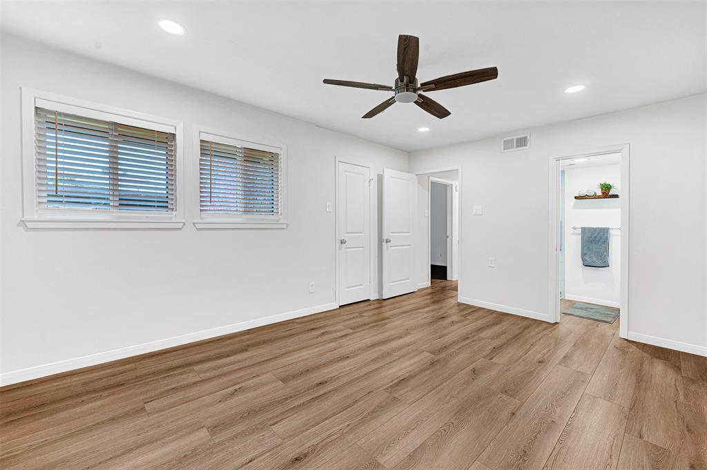 2809 Rio Branco Street, Unit 102 Farmers Branch, TX 75234 - Photo 16 of 21 a view of empty room with wooden floor and ceiling fan