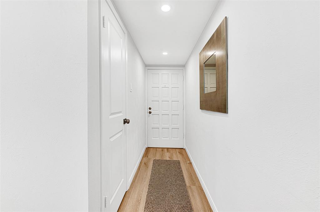 2809 Rio Branco Street, Unit 102 Farmers Branch, TX 75234 - Photo 4 of 21 a view of a hallway with wooden floor and staircase