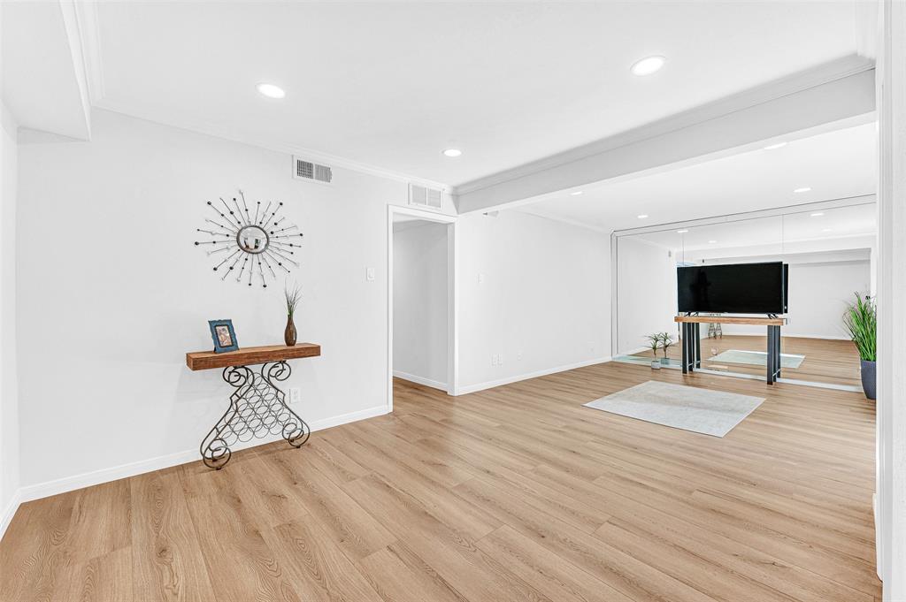 2809 Rio Branco Street, Unit 102 Farmers Branch, TX 75234 - Photo 5 of 21 a view of empty room with wooden floor and chair