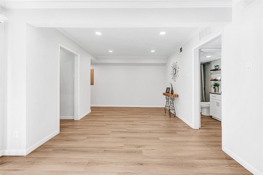 2809 Rio Branco Street, Unit 102 Farmers Branch, TX 75234 - Photo 6 of 21 a view of empty room with wooden floor