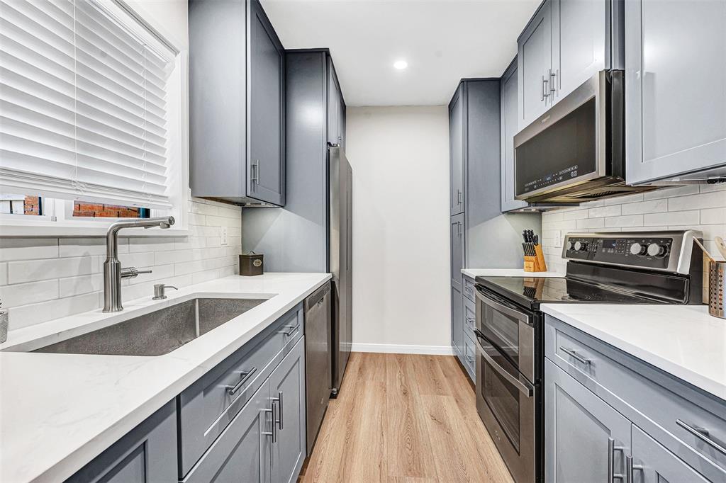 2809 Rio Branco Street, Unit 102 Farmers Branch, TX 75234 - Photo 8 of 21 a kitchen with a sink stove and microwave