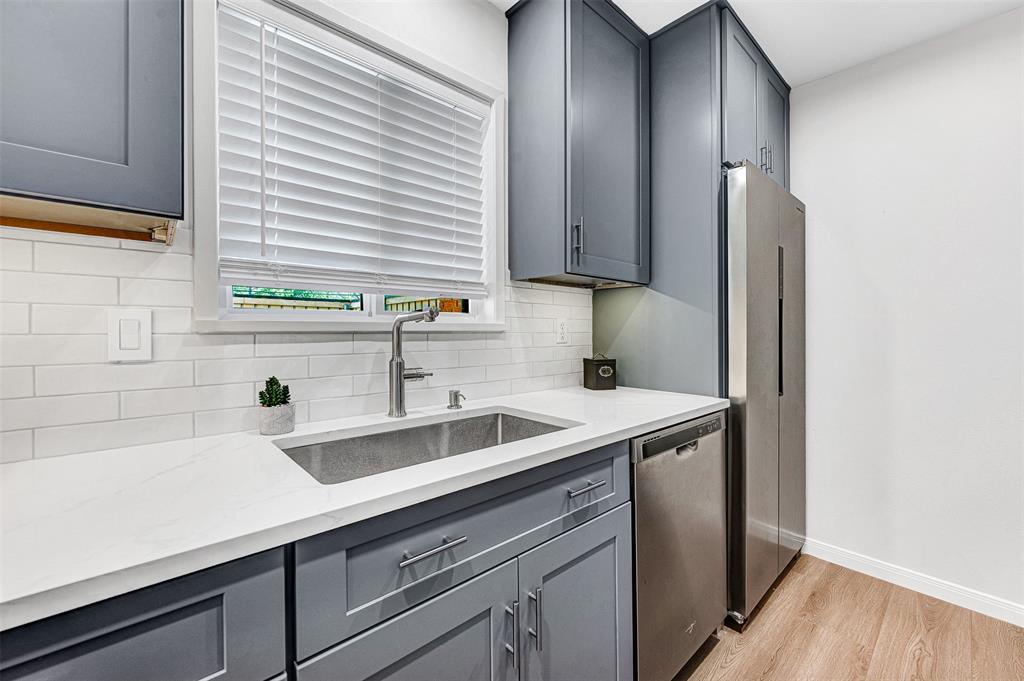 2809 Rio Branco Street, Unit 102 Farmers Branch, TX 75234 - Photo 9 of 21 a kitchen with a sink and cabinets
