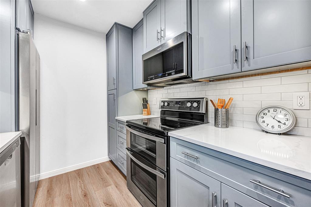 2809 Rio Branco Street, Unit 102 Farmers Branch, TX 75234 - Photo 10 of 21 a kitchen with a stove and a microwave