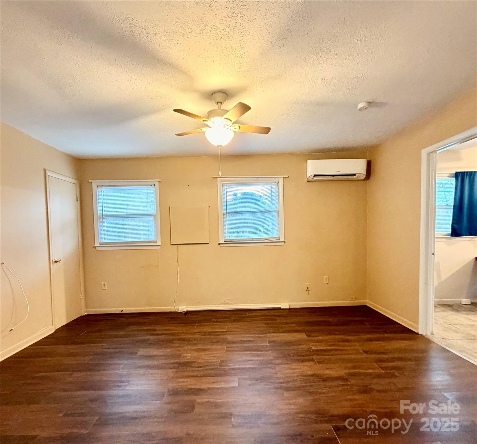 9 Riddle Road Swannanoa, NC 28778 - Photo 2 of 21 a view of a room with wooden floor and a ceiling fan