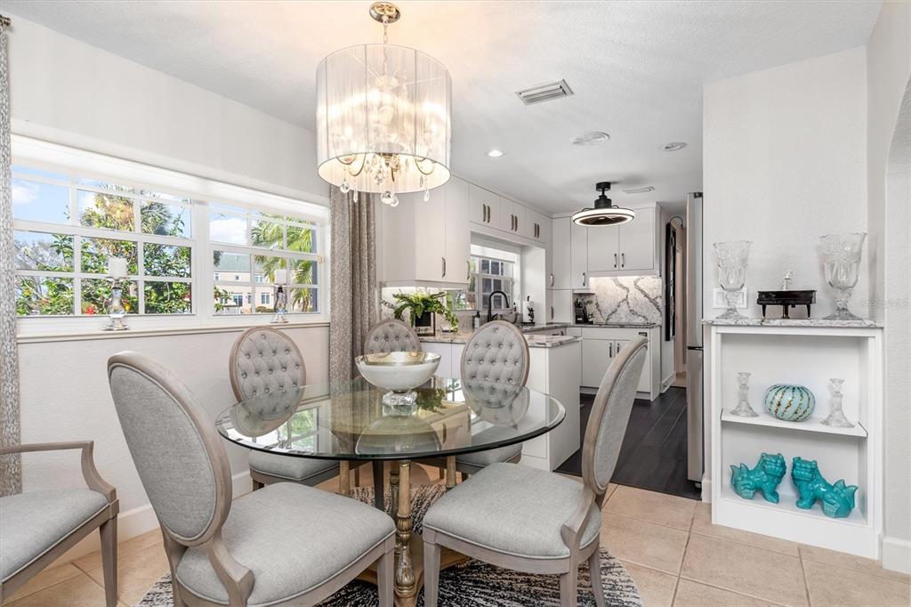 374 Severin Road Southeast Port Charlotte, FL 33952 - Photo 12 of 67 a view of a dining room with furniture a chandelier and large windows
