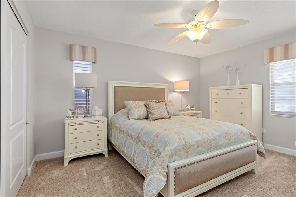 374 Severin Road Southeast Port Charlotte, FL 33952 - Photo 32 of 67 a bedroom with a bed and a chandelier