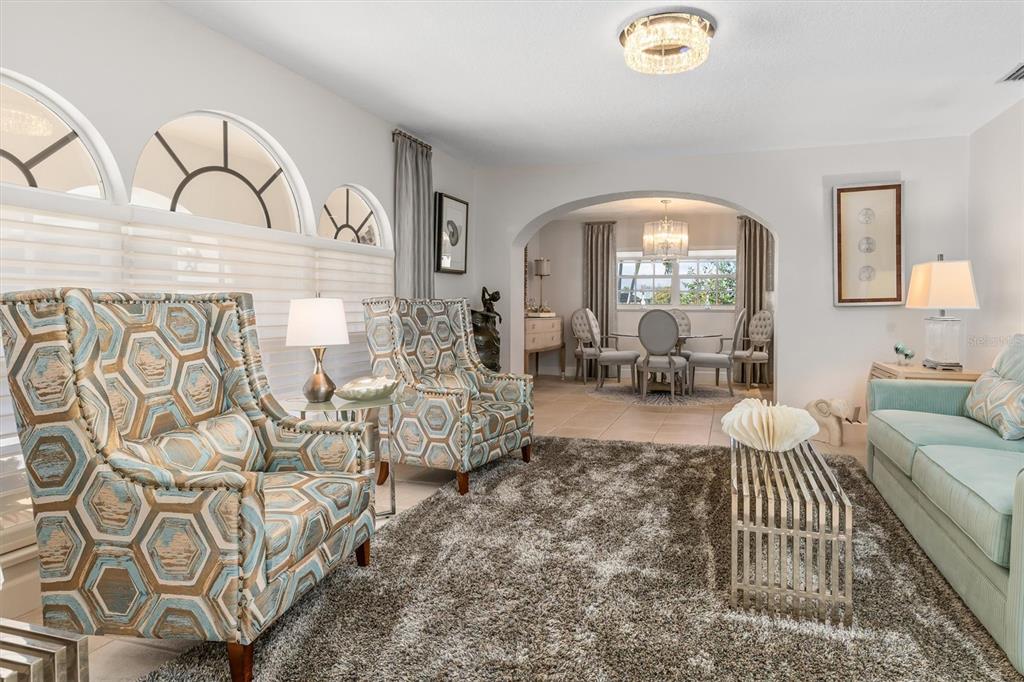 374 Severin Road Southeast Port Charlotte, FL 33952 - Photo 10 of 67 a living room with furniture and a large window