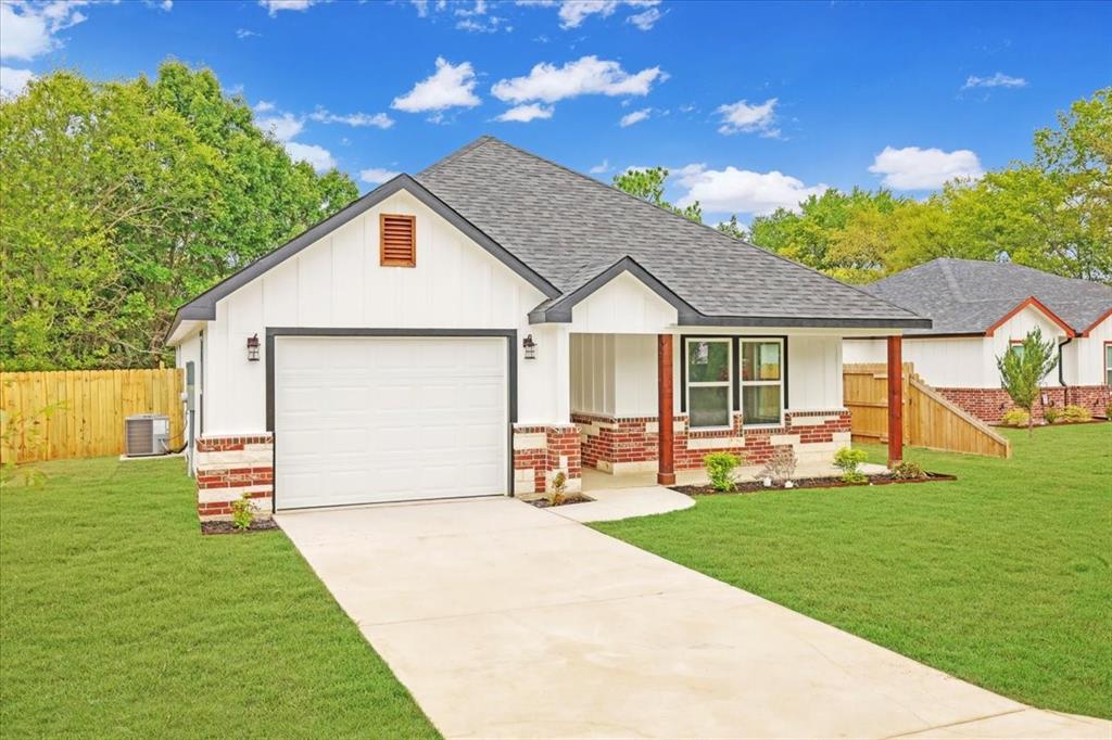 111 North Oak Street Ector, TX 75439 - Photo 12 of 34 a front view of a house with a yard and porch