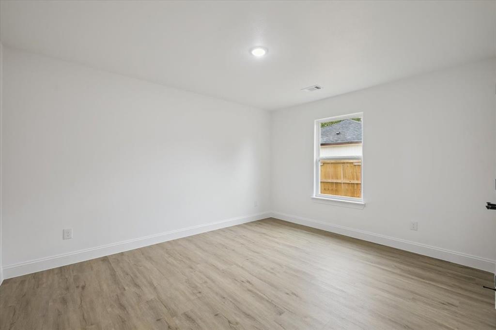 111 North Oak Street Ector, TX 75439 - Photo 16 of 34 an empty room with a window