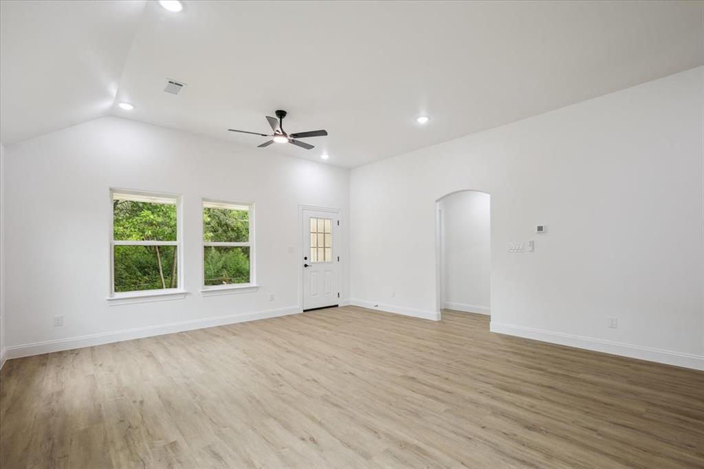 111 North Oak Street Ector, TX 75439 - Photo 21 of 34 wooden floor in an empty room with a window