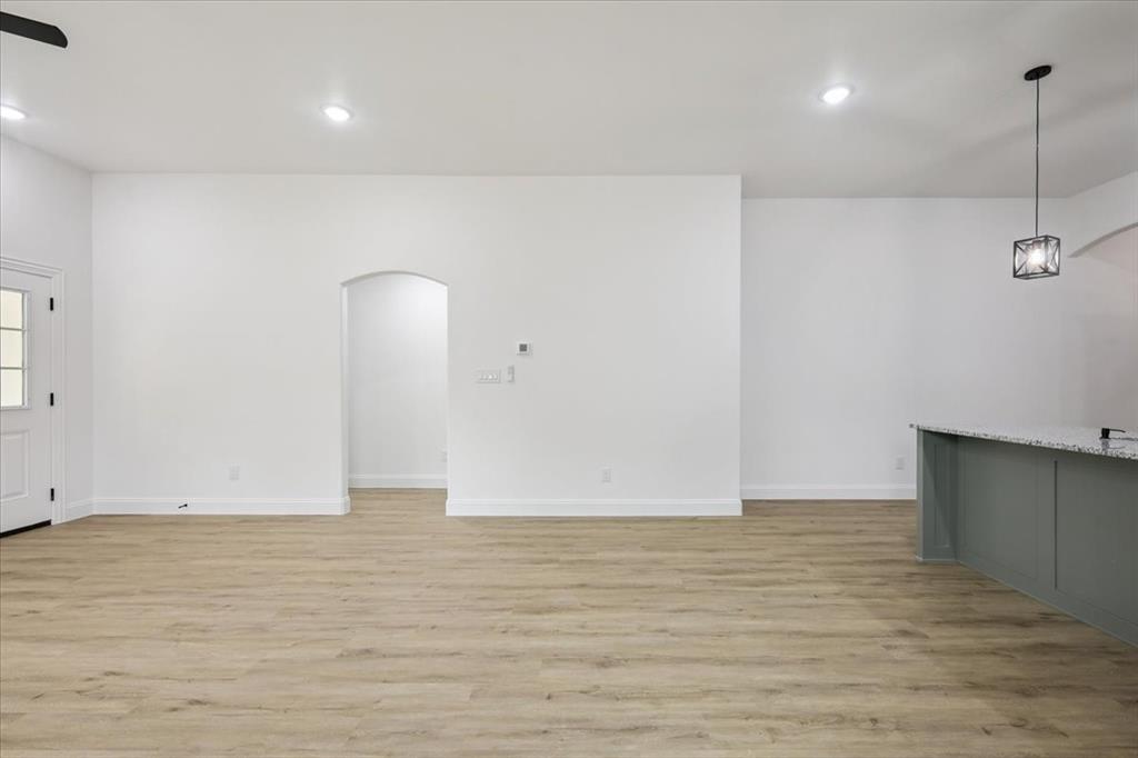 111 North Oak Street Ector, TX 75439 - Photo 22 of 34 a view of an empty room with wooden floor