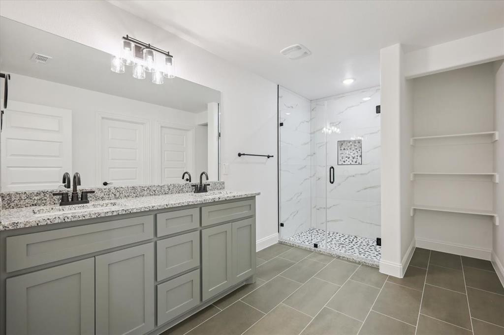 111 North Oak Street Ector, TX 75439 - Photo 24 of 34 a spacious bathroom with a granite countertop sink a toilet a mirror and shower