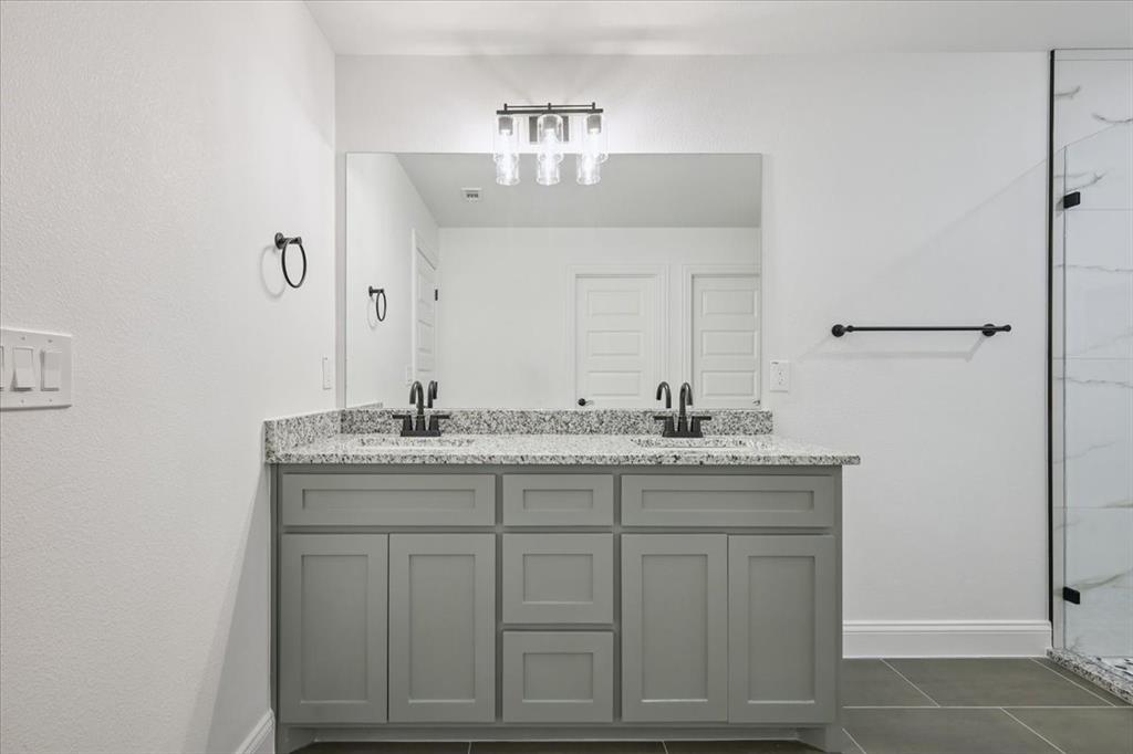 111 North Oak Street Ector, TX 75439 - Photo 26 of 34 a bathroom with a granite countertop sink and a mirror