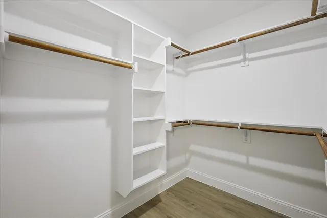 a view of walk in closet with empty racks