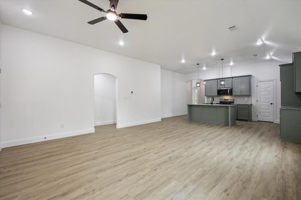 111 North Oak Street Ector, TX 75439 - Photo 29 of 34 a view of kitchen with refrigerator microwave and stove