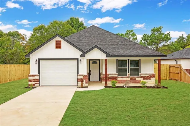 a front view of house with yard outdoor seating and green space