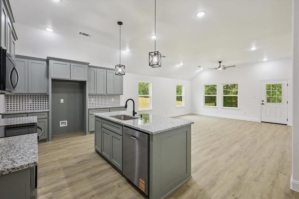 111 North Oak Street Ector, TX 75439 - Photo 6 of 34 a kitchen with stainless steel appliances granite countertop a sink stove and refrigerator
