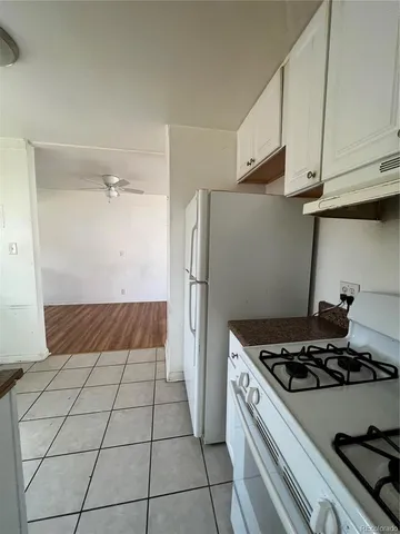 a kitchen with a stove and a refrigerator