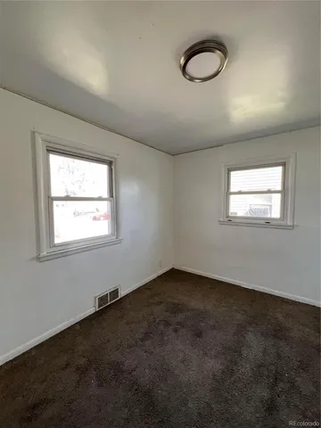 an empty room with a empty space and a window