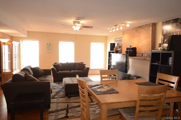 a living room with furniture and a chandelier