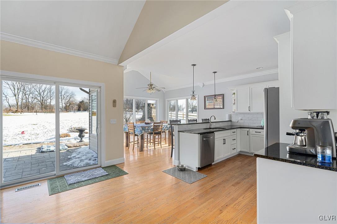 2930 Willow Street Coplay, PA 18037 - Photo 22 of 50 a kitchen with stainless steel appliances granite countertop a refrigerator a sink a stove and white cabinets with wooden floor