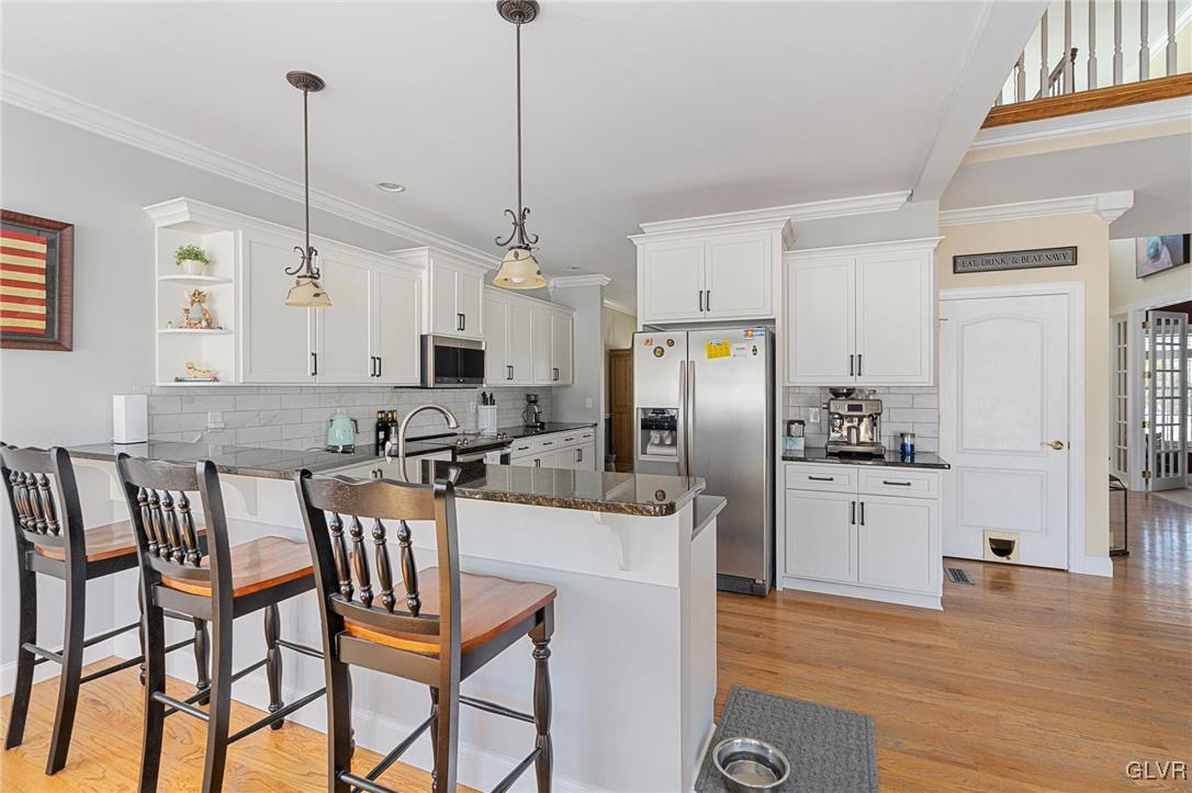 2930 Willow Street Coplay, PA 18037 - Photo 24 of 50 a kitchen with stainless steel appliances kitchen island granite countertop a refrigerator a stove a kitchen island with a dining table and chairs