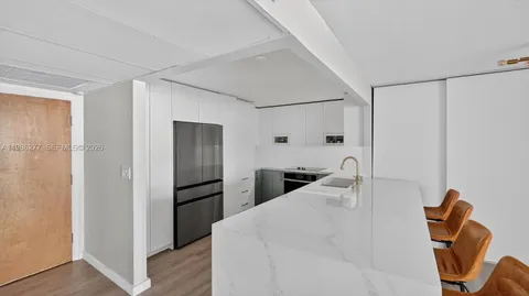 a kitchen with stainless steel appliances a refrigerator and a counter top space