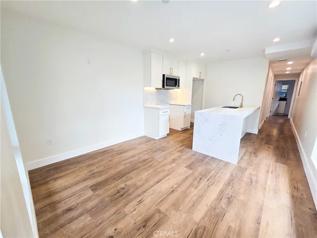 a view of kitchen with cabinets and wooden floor