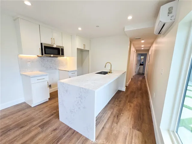 a view of kitchen with sink microwave and refrigerator