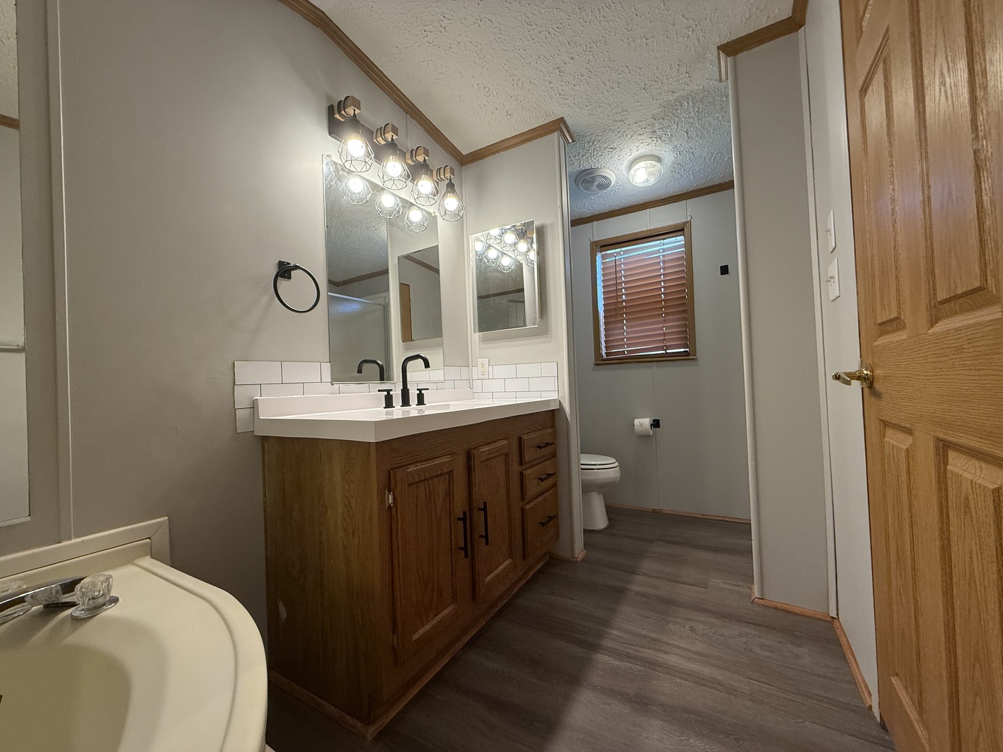317 Pleasant Terrace Matteson, IL 60443 - Photo 12 of 23 a bathroom with a double vanity sink and a mirror