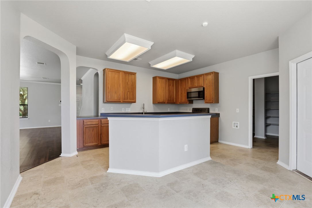 8716 Starview Street Temple, TX 76502 - Photo 9 of 36 Wide view of the open-concept kitchen highlighting the large center island