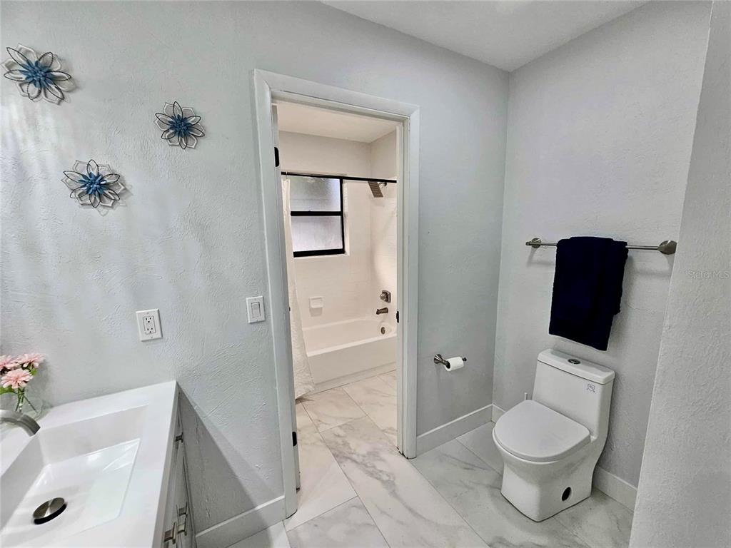 5407 Southwest 82 Terrace Gainesville, FL 32608 - Photo 22 of 31 a bathroom with a toilet sink and shower