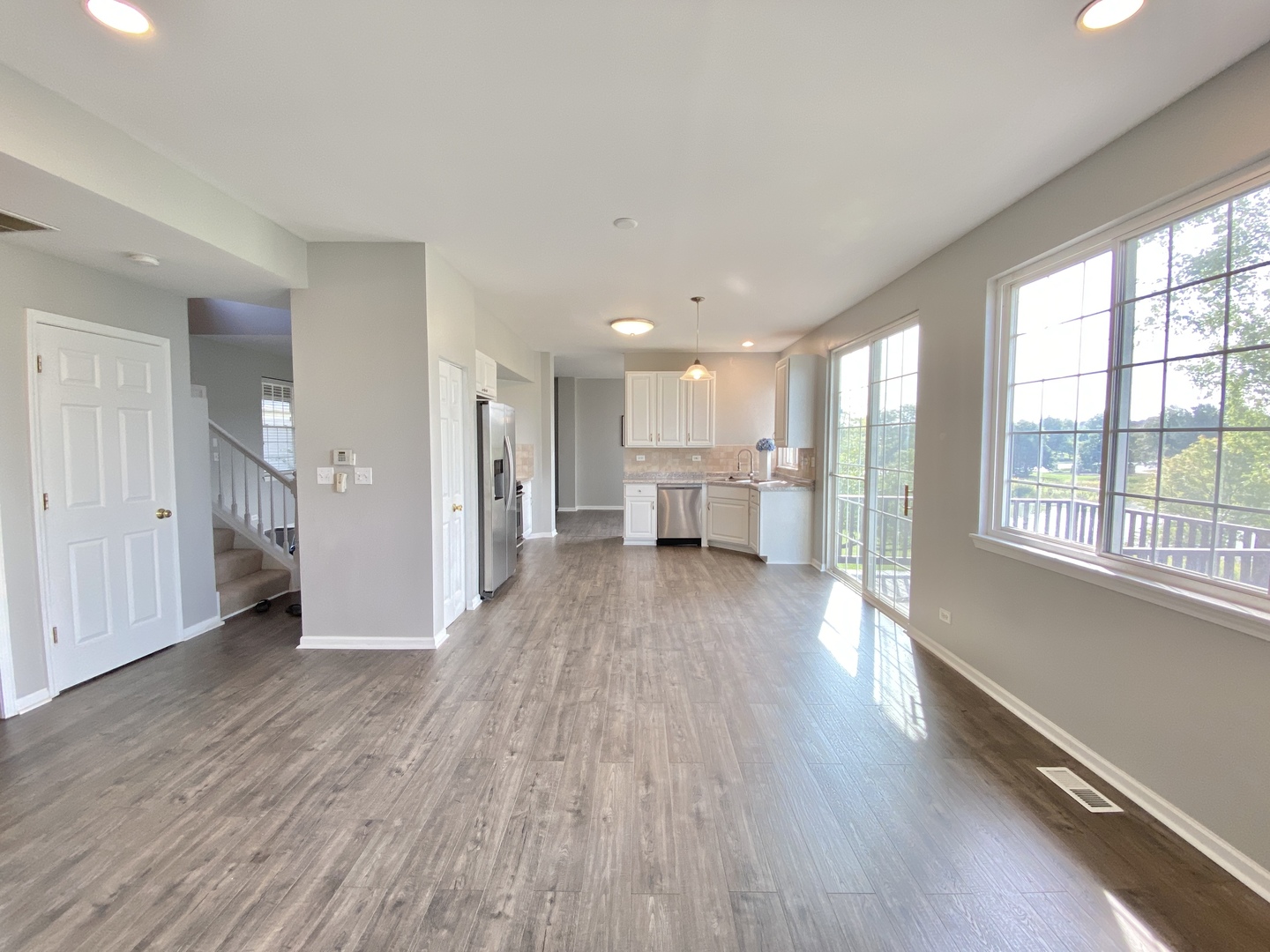 2443 Baldwin Court Aurora, IL 60503 - Photo 12 of 51 a view of a big room with wooden floor and windows