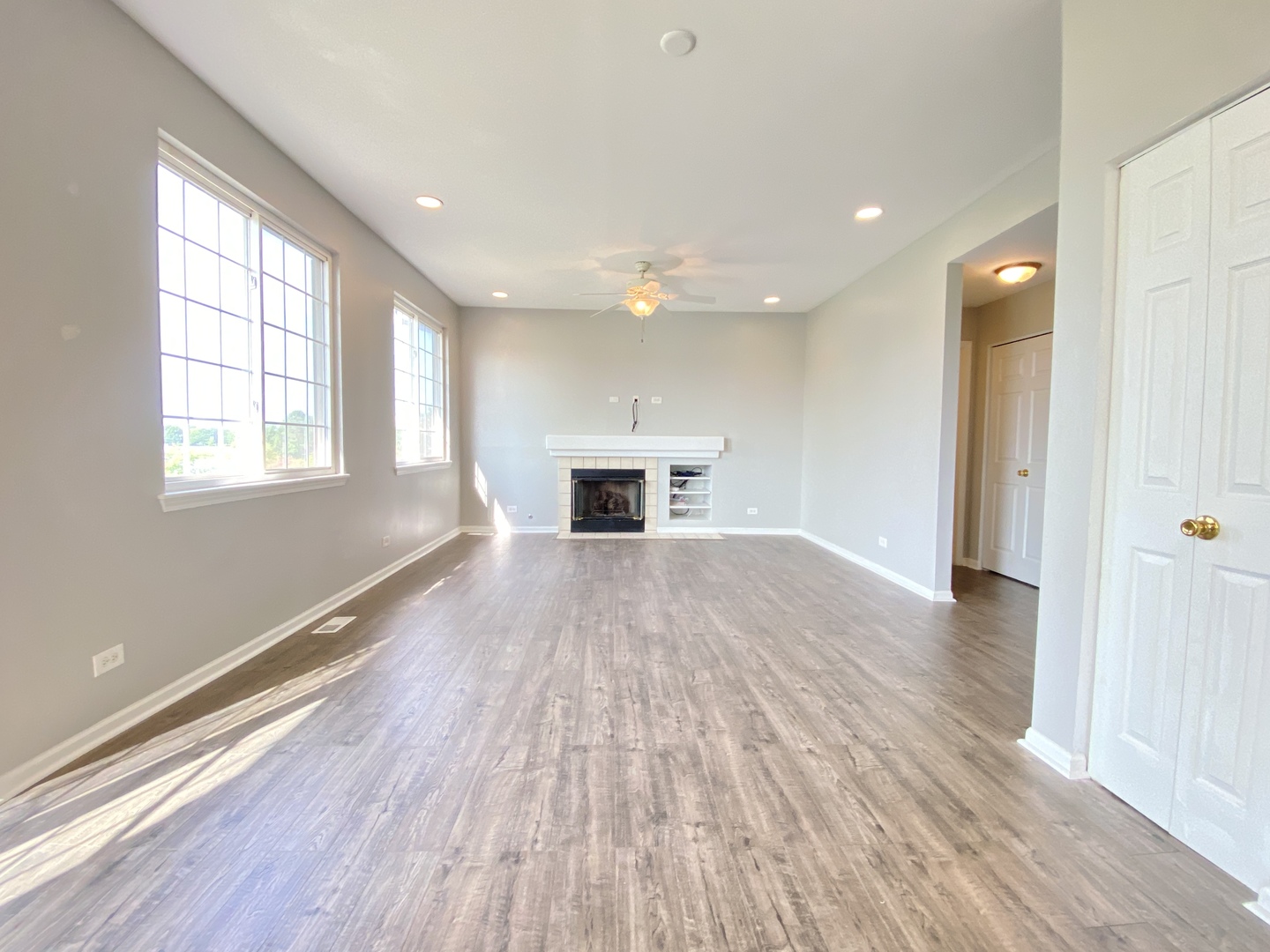 2443 Baldwin Court Aurora, IL 60503 - Photo 15 of 51 an empty room with wooden floor cabinet and windows