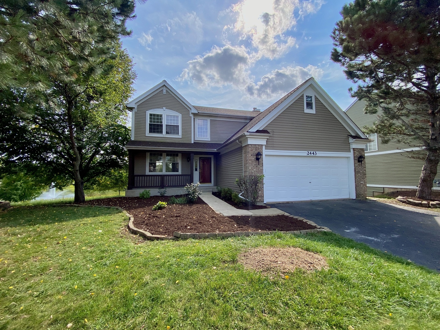 2443 Baldwin Court Aurora, IL 60503 - Photo 2 of 51 a front view of a house with garden