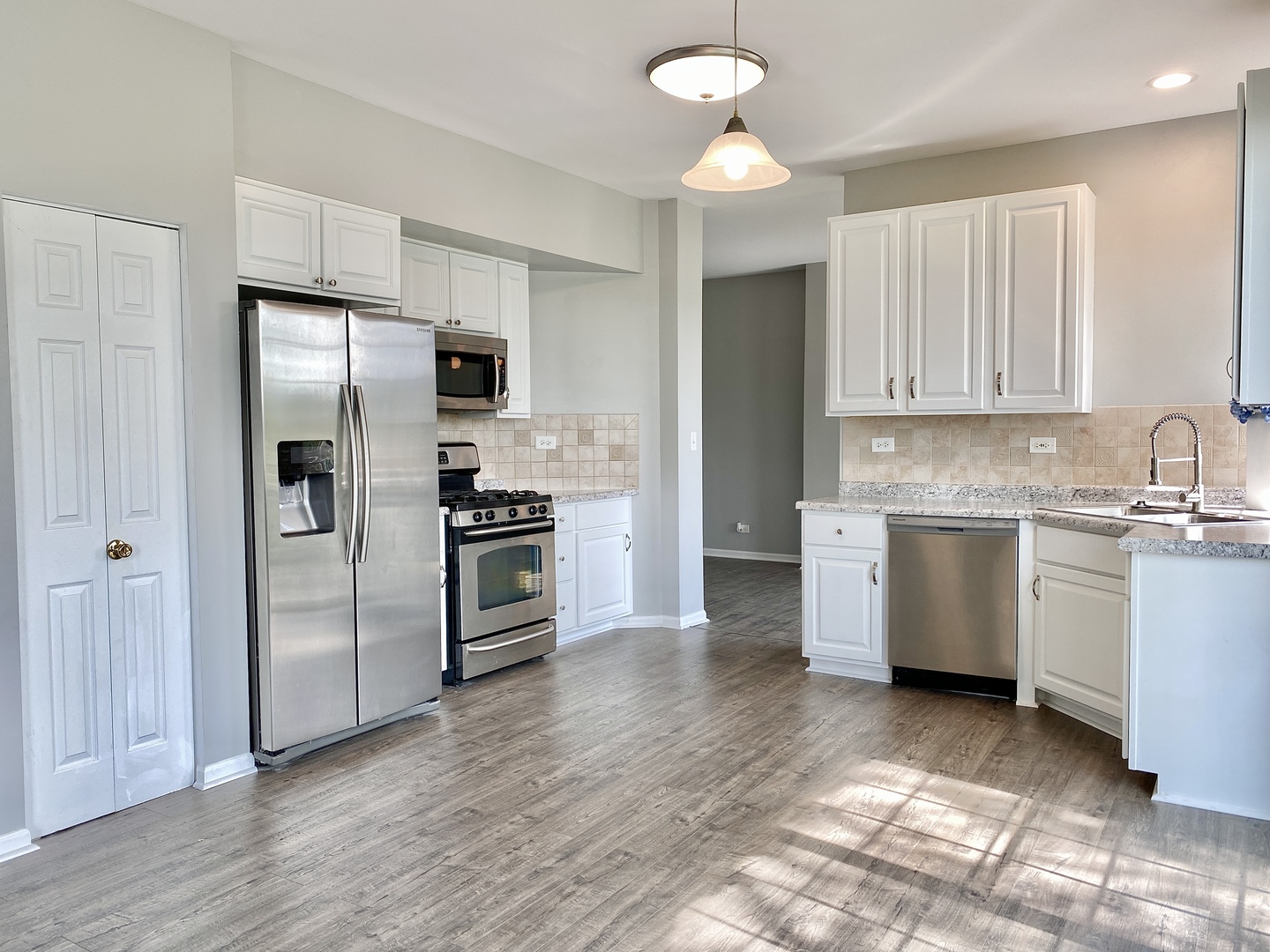 2443 Baldwin Court Aurora, IL 60503 - Photo 9 of 51 a kitchen with a refrigerator sink and cabinets