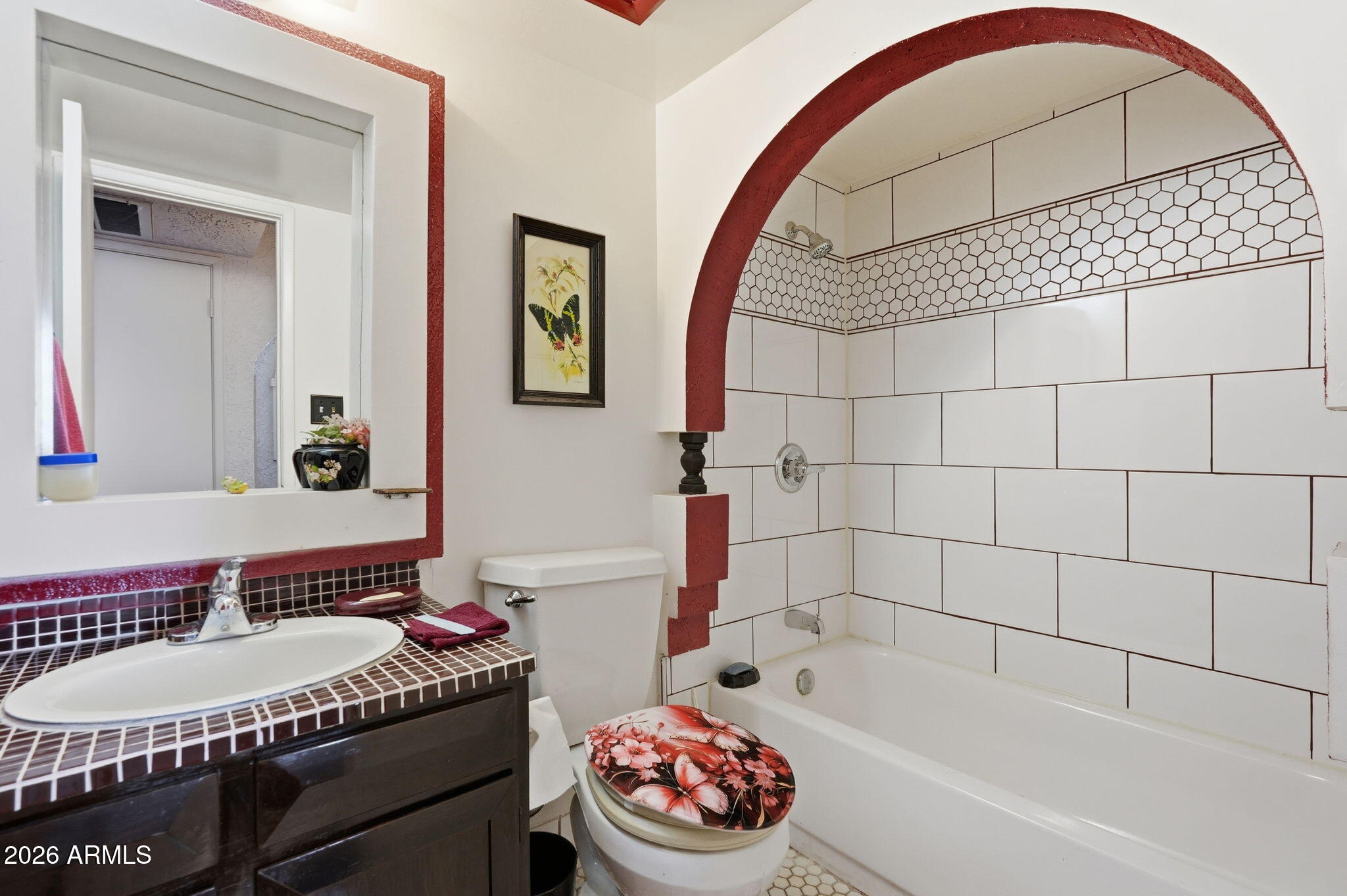 4702 East Alta Vista Road Phoenix, AZ 85042 - Photo 13 of 20 a bathroom with a tub a sink and a mirror