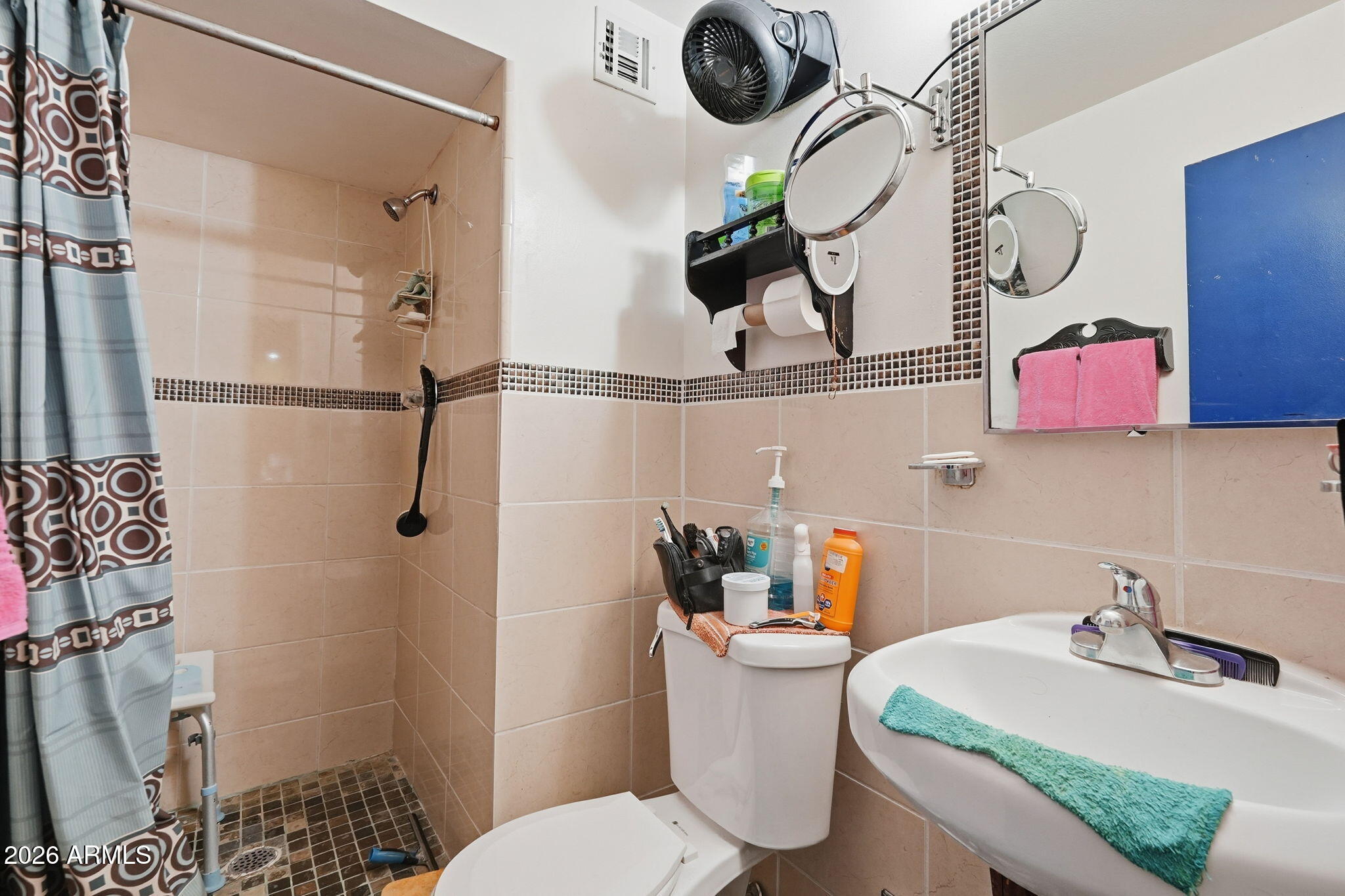 4702 East Alta Vista Road Phoenix, AZ 85042 - Photo 14 of 20 a bathroom with a sink mirror vanity and toilet