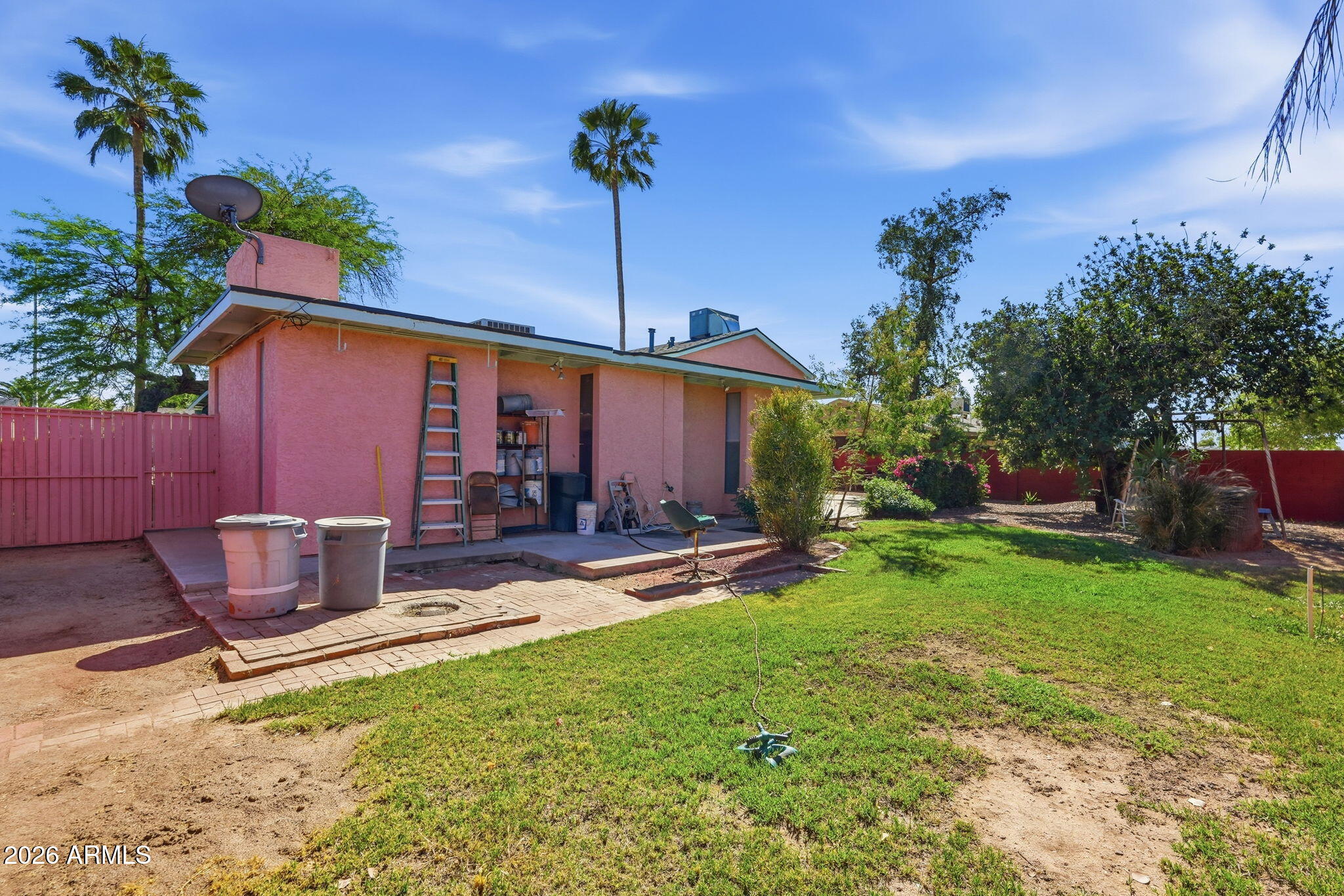 4702 East Alta Vista Road Phoenix, AZ 85042 - Photo 17 of 20 a backyard of a house with table and chairs